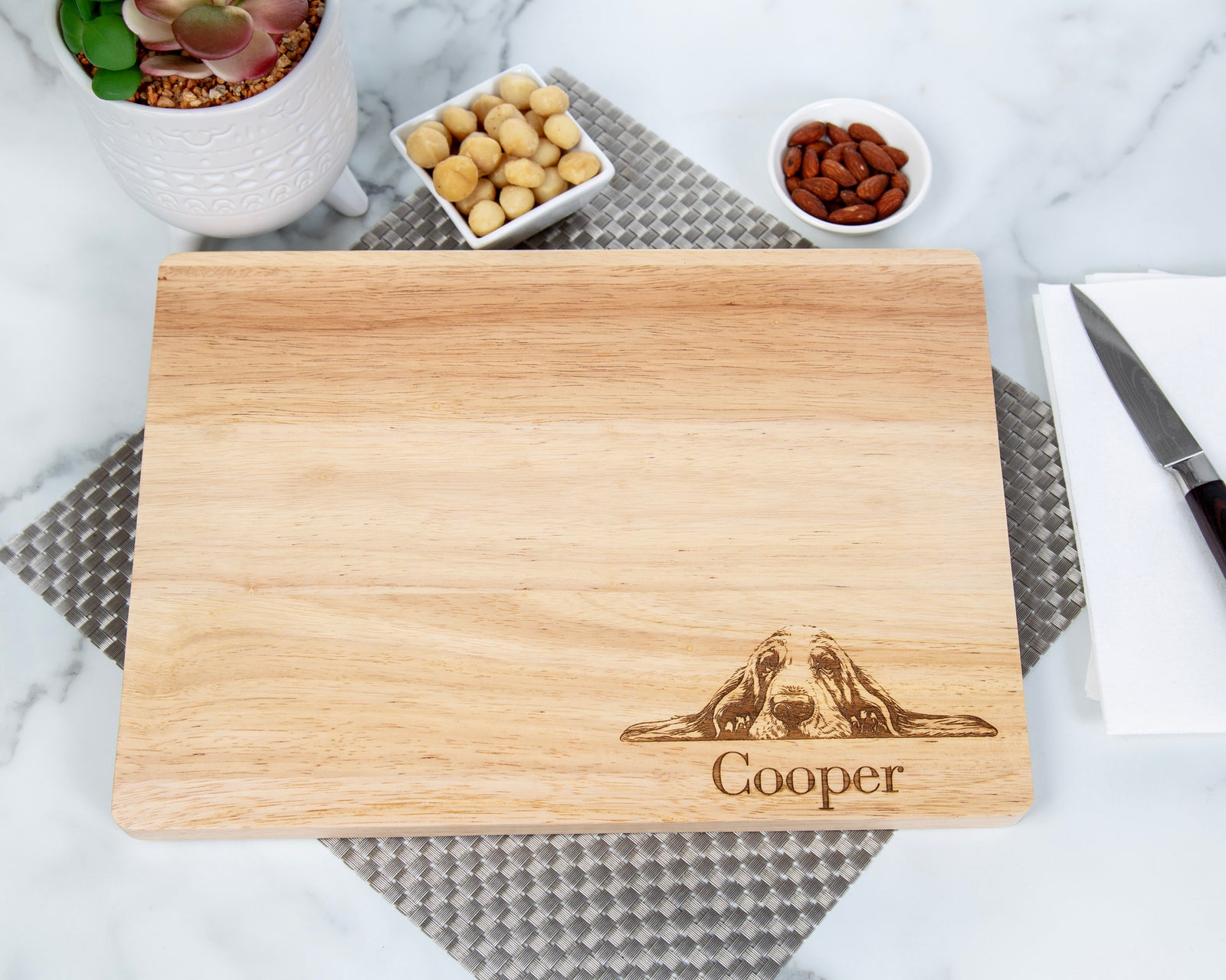 This personalized Basset Hound Cutting Board makes a perfect gift for any dog lover! Crafted from beautiful bamboo and engraved with a special French Bulldog design, this cutting board is the perfect gift for any household. With a handy juice groove and grooved handle, this cutting board is both stylish and practical—perfect for holidays, birthdays, and housewarming gifts for both him and her.