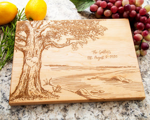 This gorgeous River Scene Design Cutting Board with Initials Inside a Heart makes a perfect wedding or anniversary gift. Crafted from high quality oak wood, it's a timeless memento that will remain a cherished keepsake for years to come. It's the perfect way to commemorate a special occasion! The board is custom engraved with the initials and a date of your choice, and its durable construction makes it perfect for continued use long after the special day.