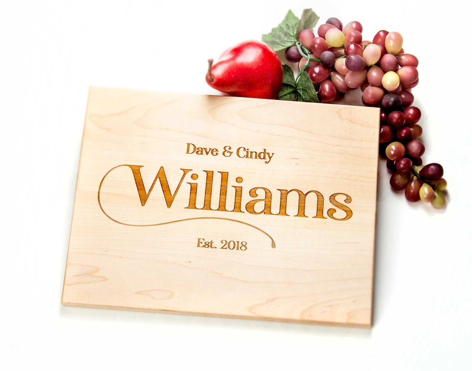 The ideal gift for any special occasion, this personalized cutting board is crafted from quality wood and features a scripted last name along the side. Its unique design makes it a perennially popular wedding, anniversary, and housewarming present. Impress the recipient with this exclusive, one-of-a-kind kitchen accessory.