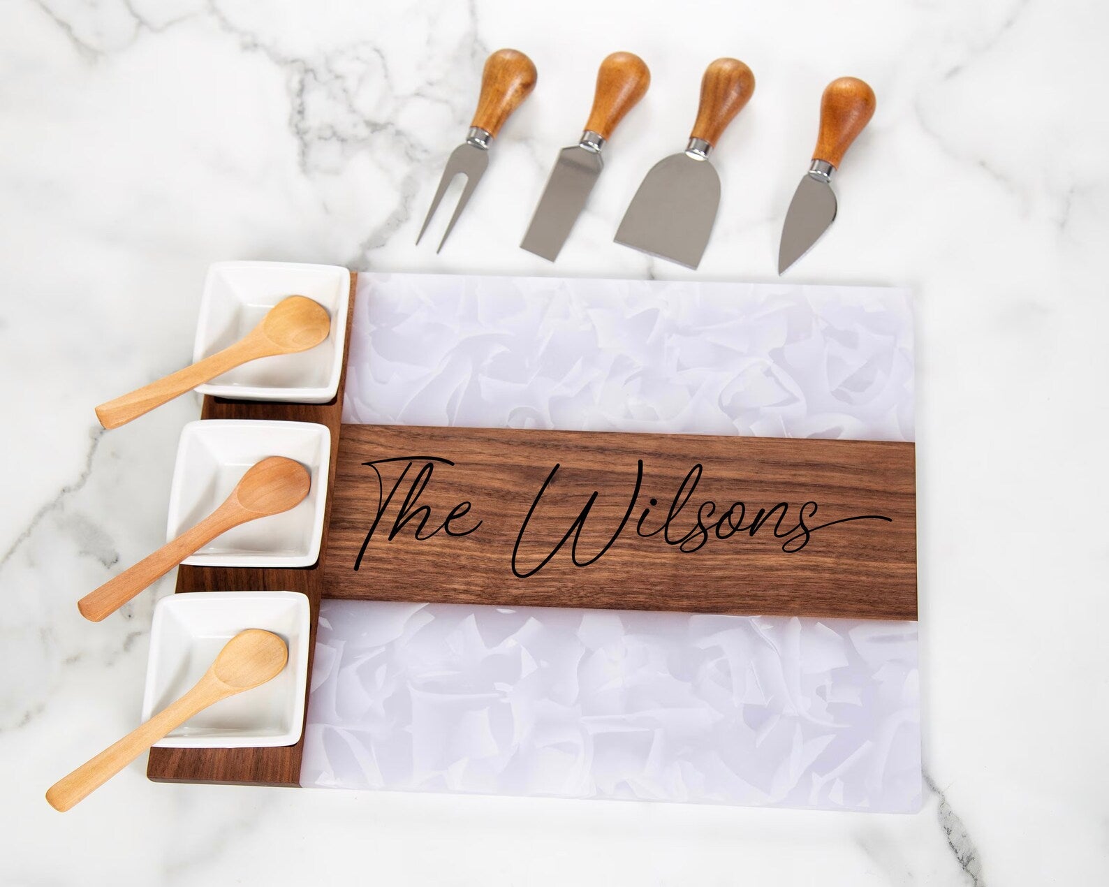 Introducing the exquisite Black Walnut and white flowing design Charcuterie Board - the ultimate gift for any celebratory occasion! Whether it's a housewarming, wedding, or special event, this stunning board is perfect for both him and her. Meticulously crafted with care, it is guaranteed to leave a lasting impression at your next gathering.