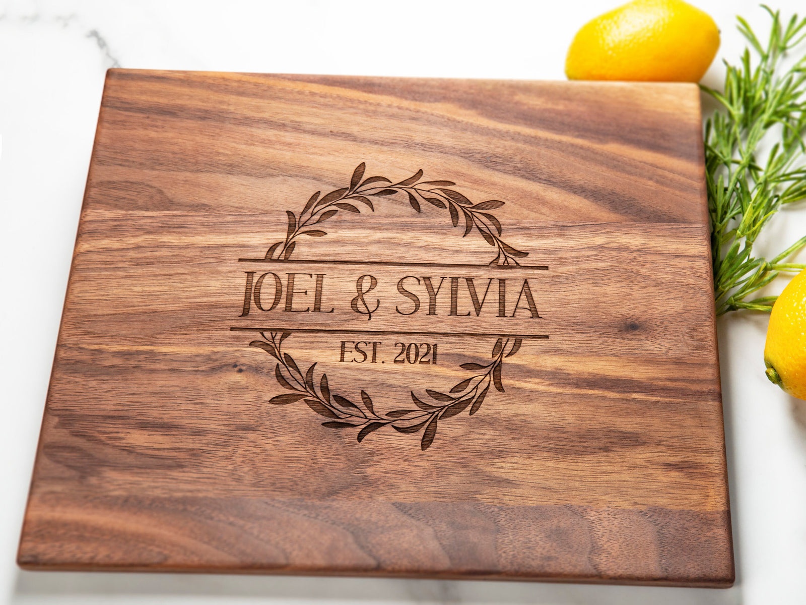 This walnut cutting board features a graceful Floral design, which adds a one-of-a-kind sophistication to any kitchen. An ideal present for special milestones such as anniversaries, weddings, and other joyous events, it will be a long-lasting and cherished part of any couple's home.