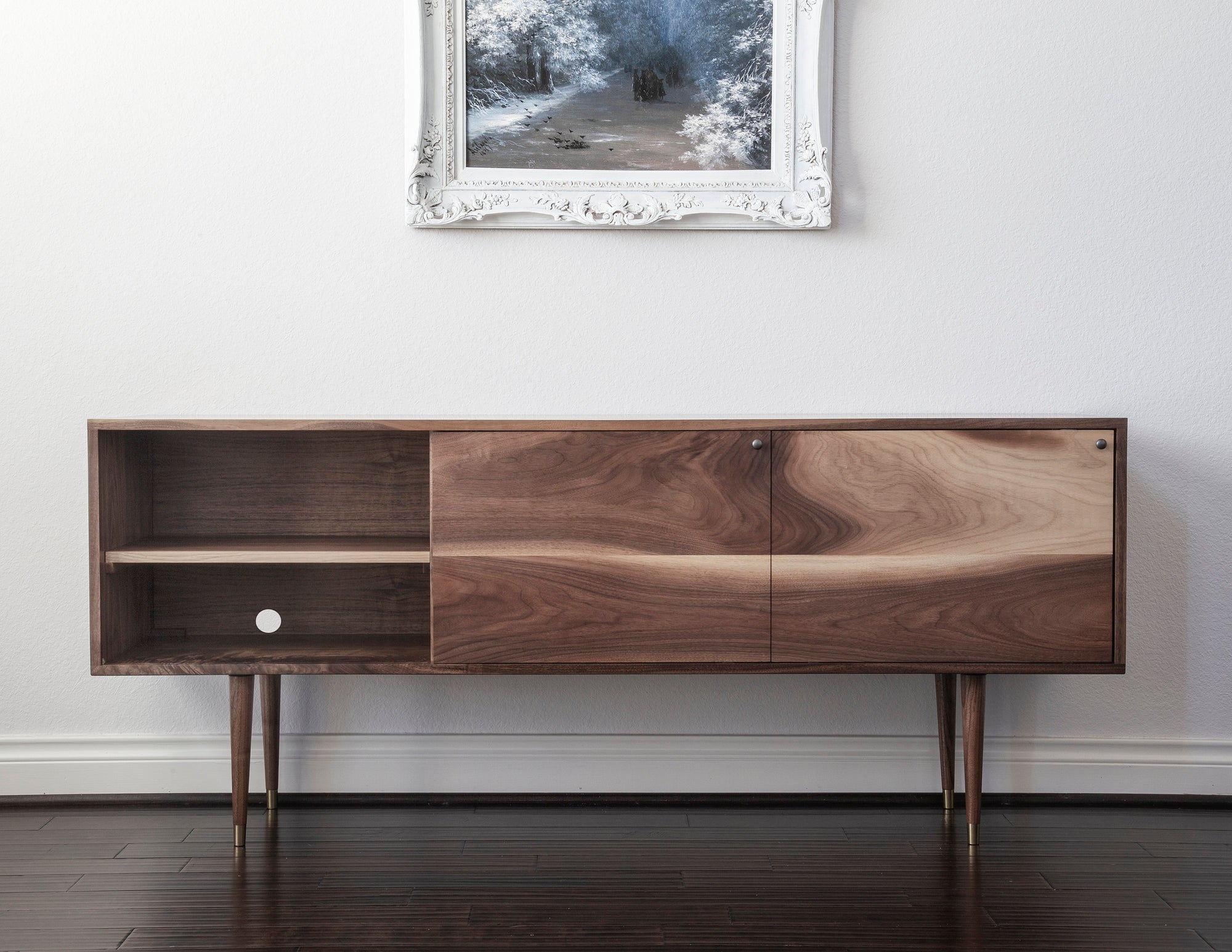 This Mid Century Credenza is the ideal addition to any home. Crafted from solid walnut, it adds a unique touch of sophistication to any décor. It's the perfect media console, TV stand, or vinyl storage cabinet for any living space, making it an ideal housewarming gift. Bring timelessness and style to any room with this beautiful piece of furniture.
